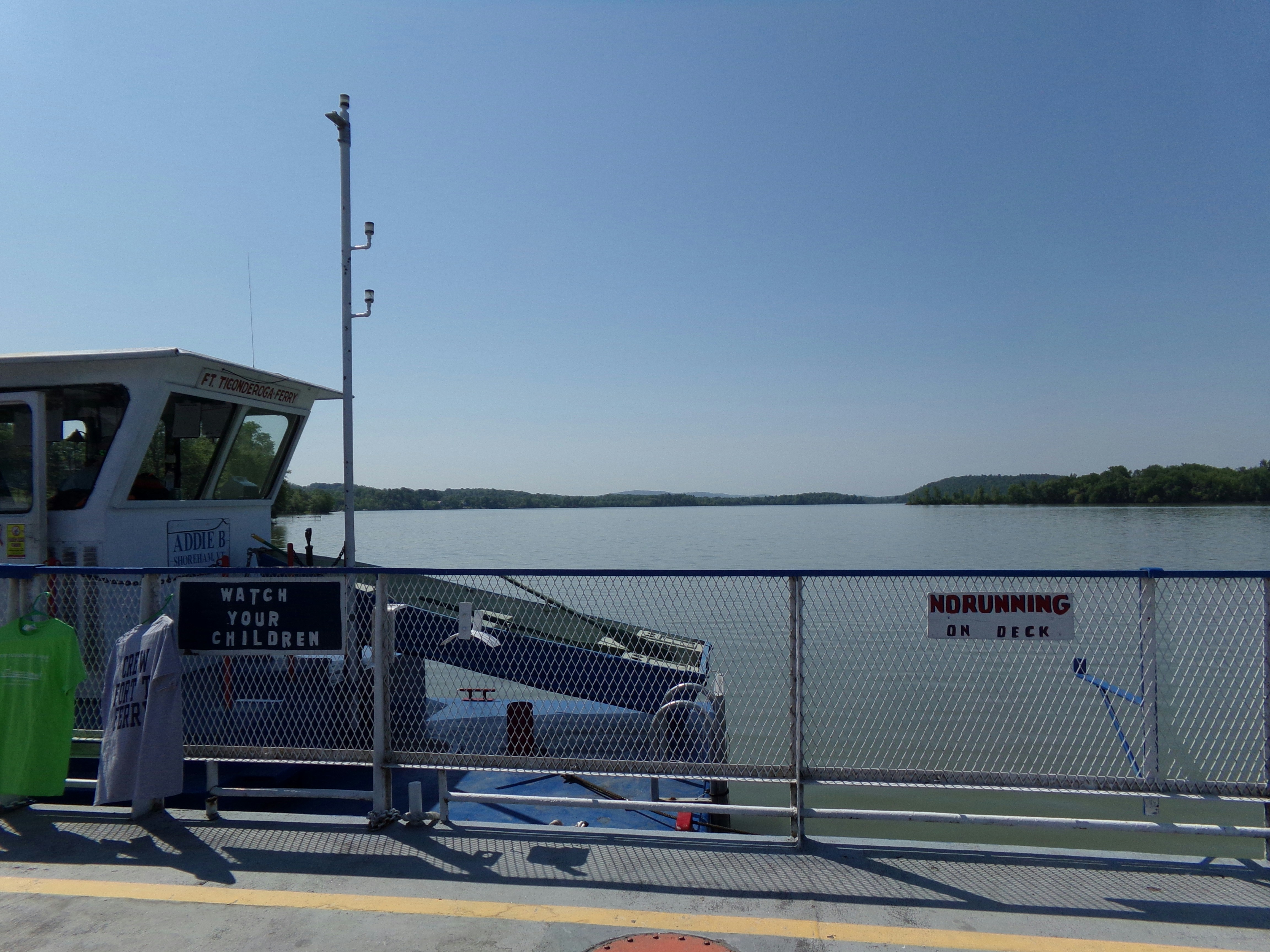 A boat is docked at a pier near the water photo Free Ft. ticonderoga