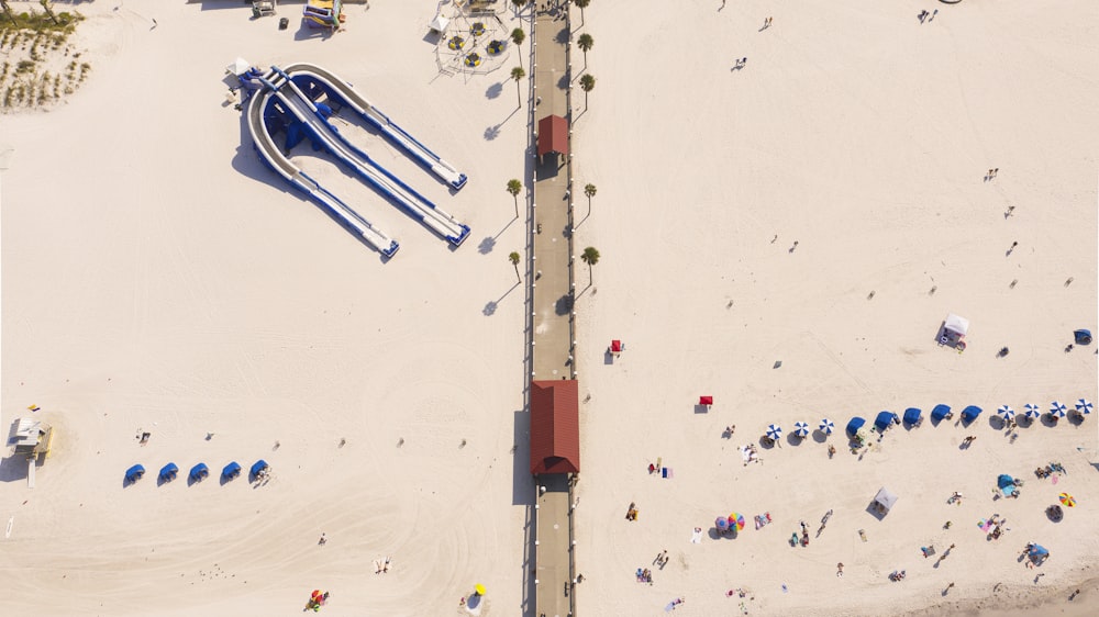 an aerial view of a beach with umbrellas and chairs