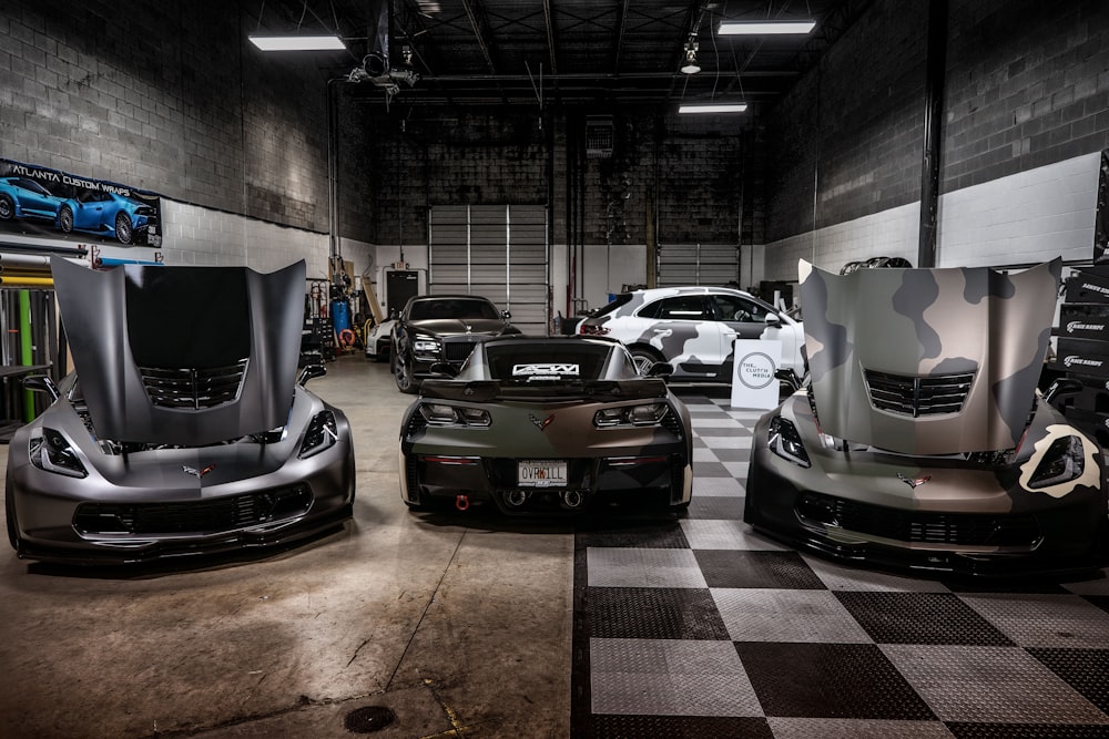 a group of cars parked inside of a garage