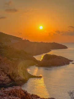 Sunset view of the cliffs and beaches of Cantabria with vibrant orange sky