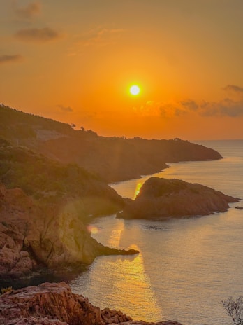 Sunset view of the cliffs and beaches of Cantabria with vibrant orange sky