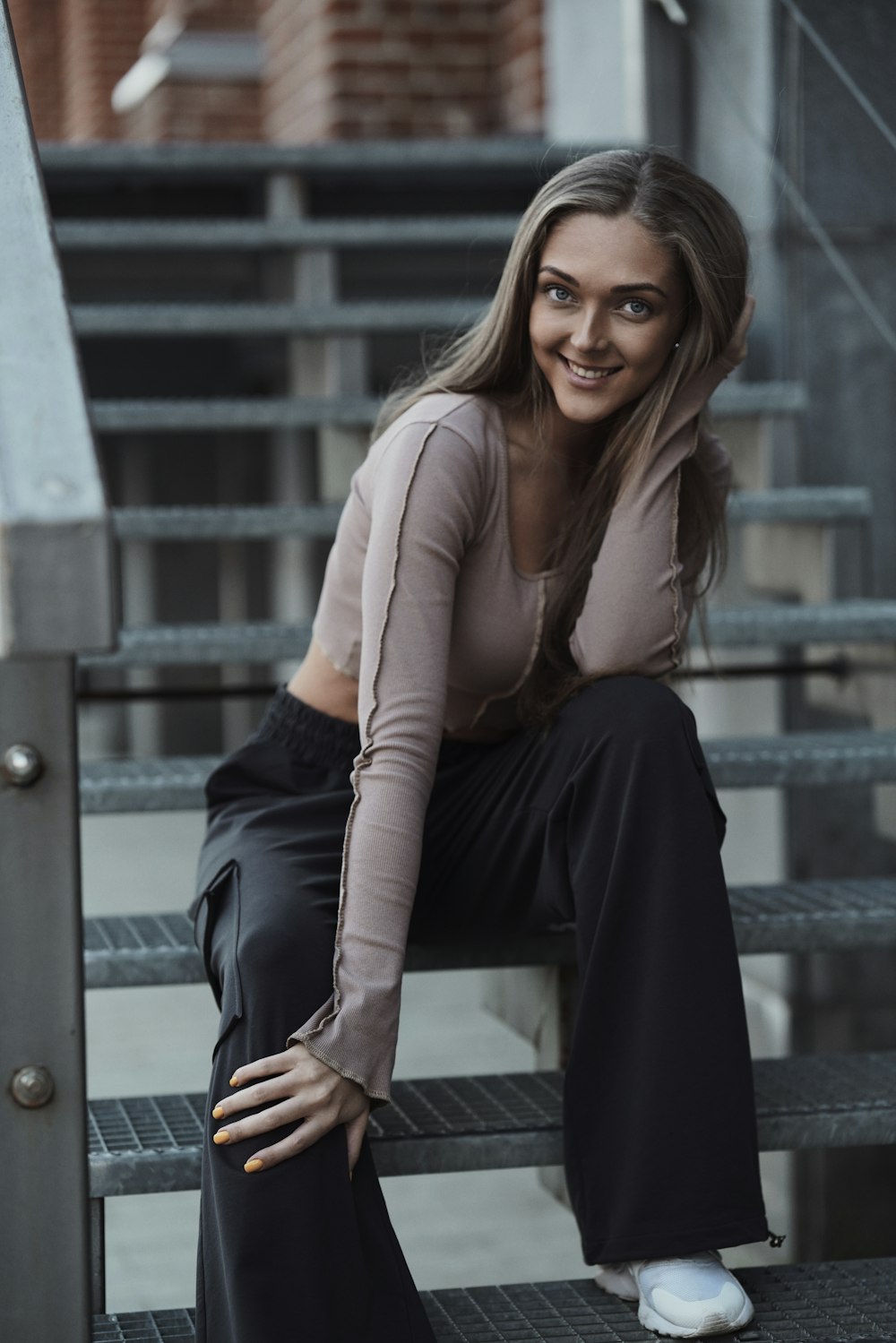 a woman is sitting on a set of stairs