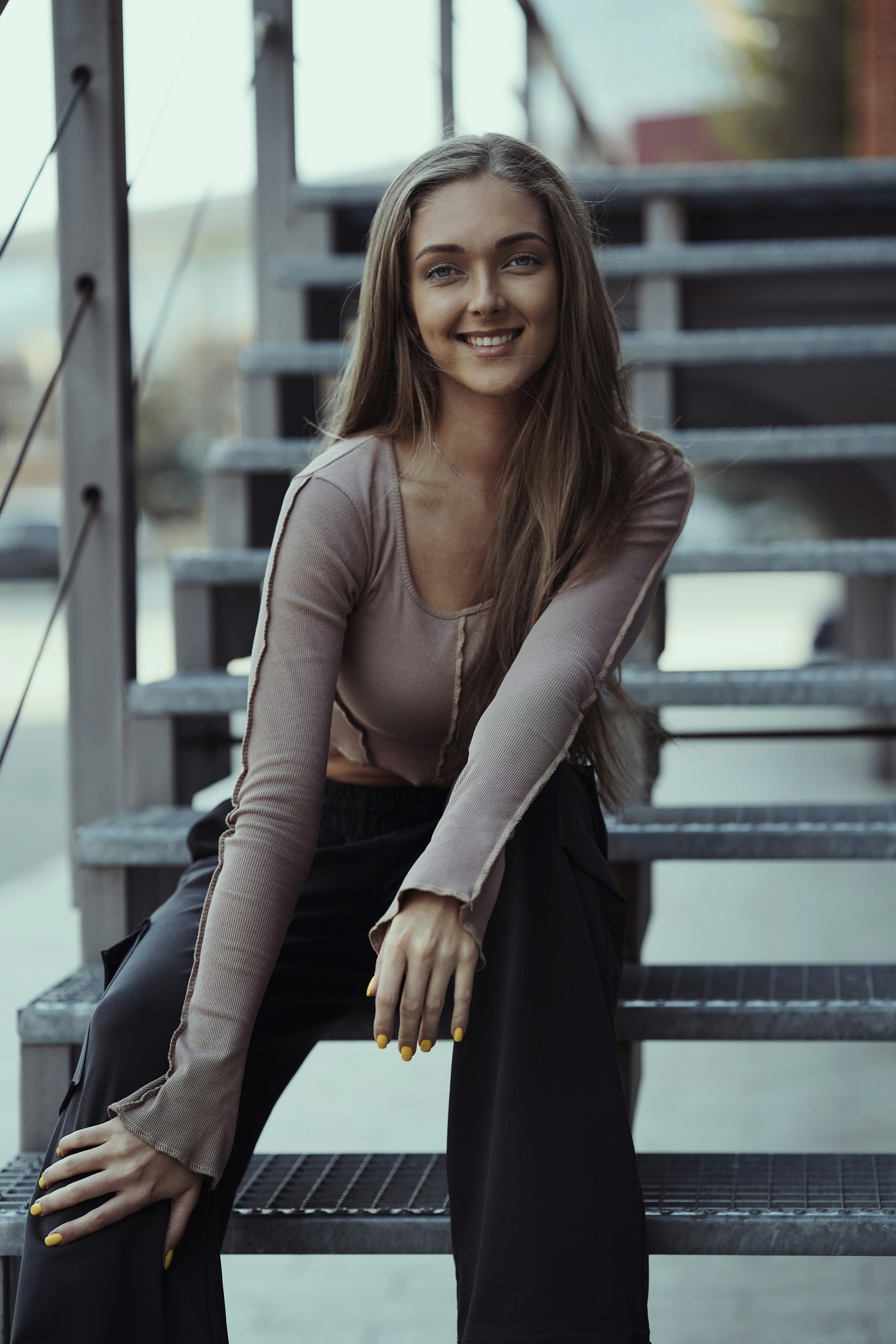 a woman is sitting on a bench smiling