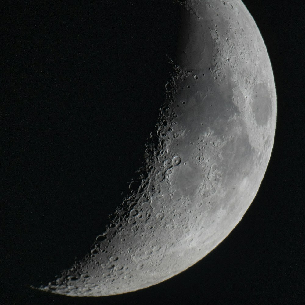 a close up of a half moon in the dark sky