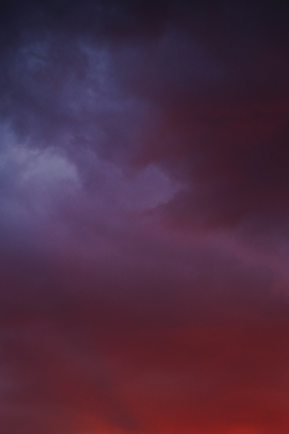 a plane flying in the sky at sunset