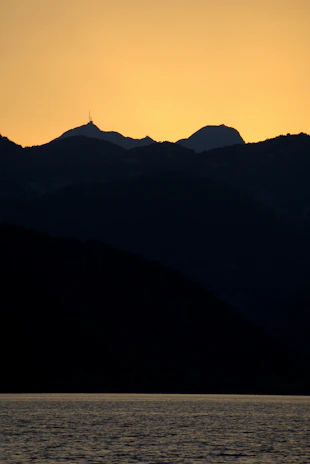 A vibrant digital painting of a serene mountain landscape at sunset, showcasing rich colors and fine detail.