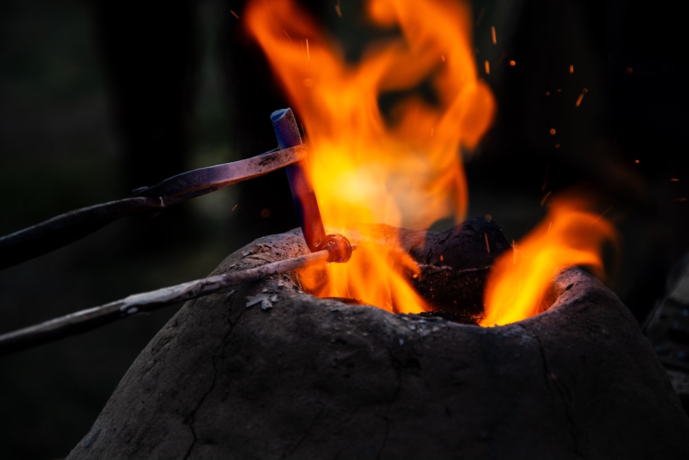 a close up of a fire with a knife sticking out of it