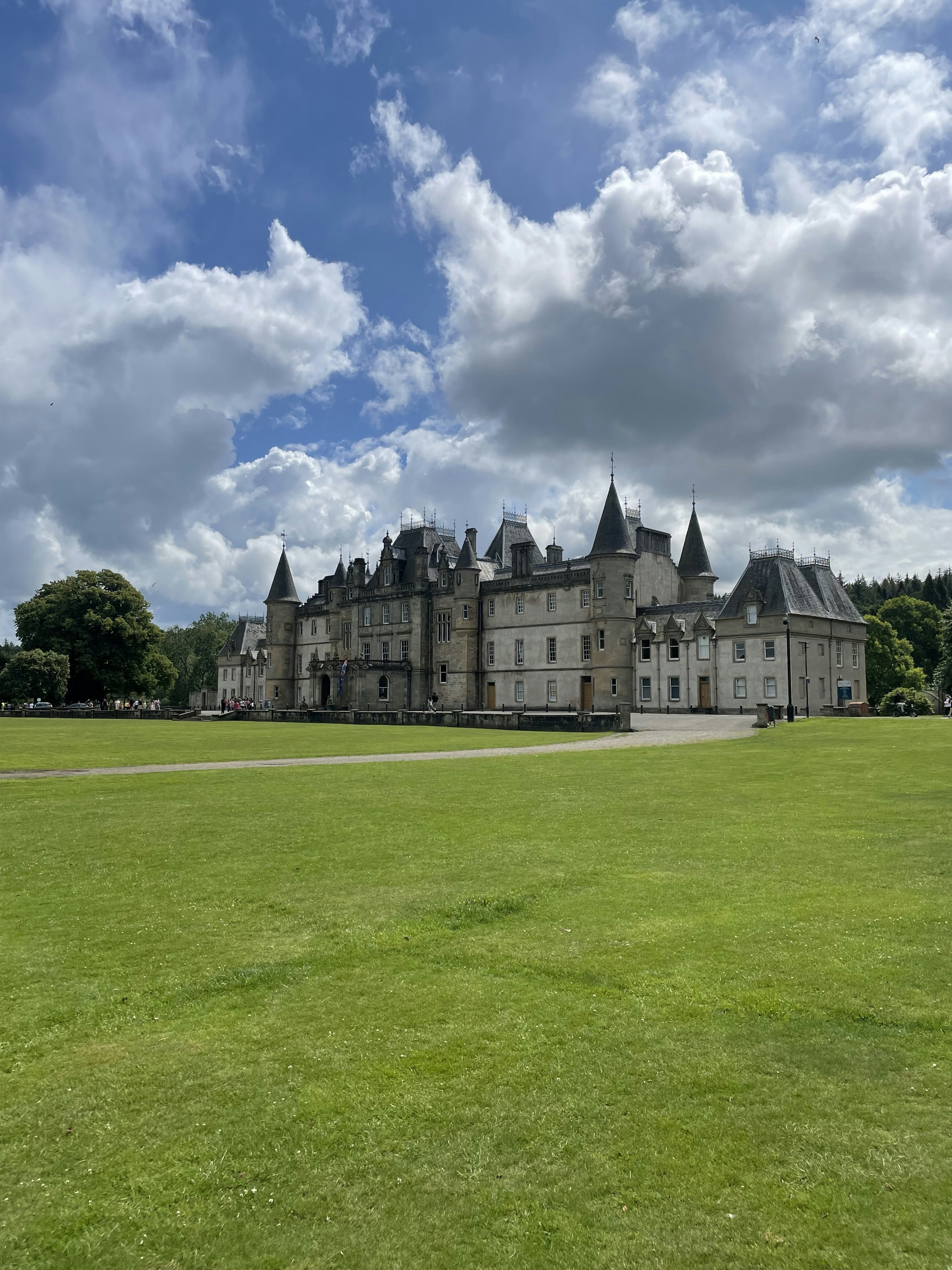 a large building sitting on top of a lush green field