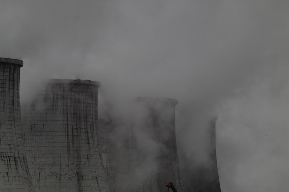 smoke billows from the cooling towers of a factory