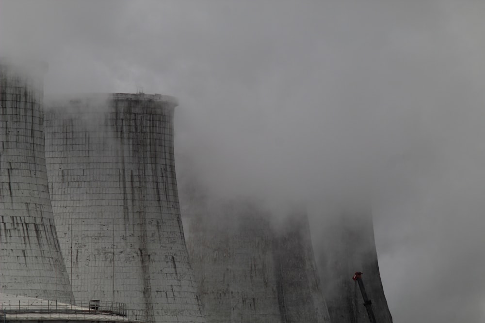 smoke billows from the cooling towers of a nuclear power plant