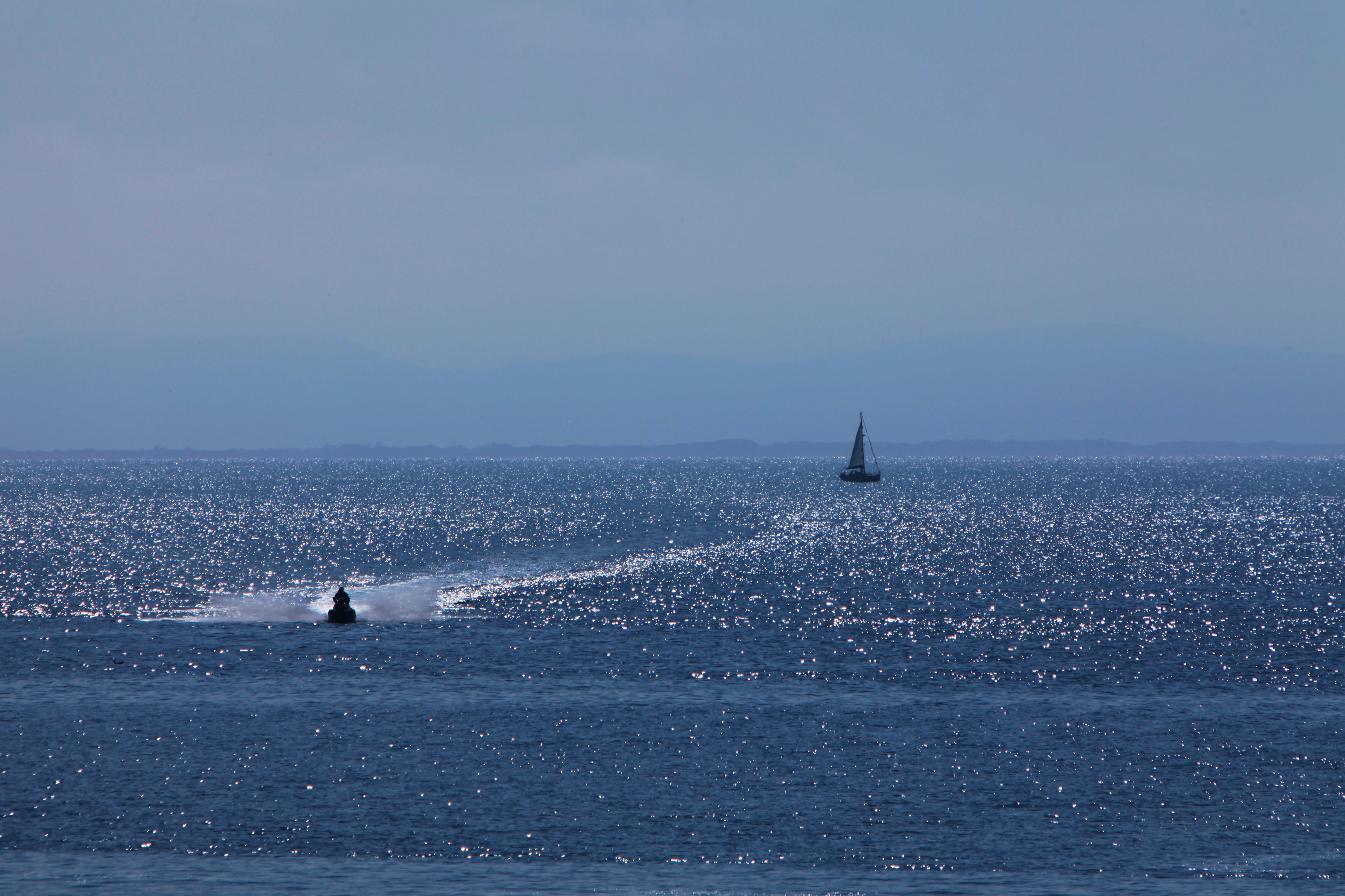 A sailboat in the middle of a body of water photo – Free Boat Image on ...