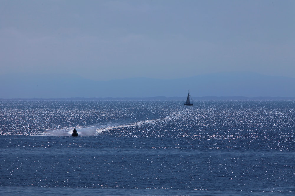 a sailboat in the middle of a body of water