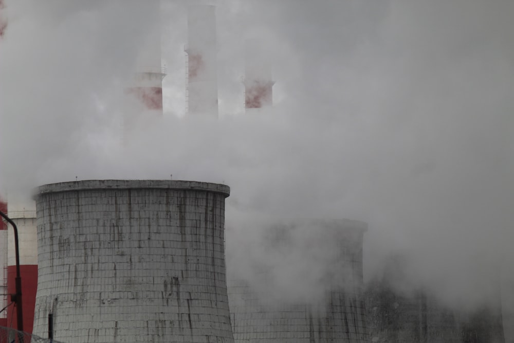 smoke billows from the stacks of cooling towers