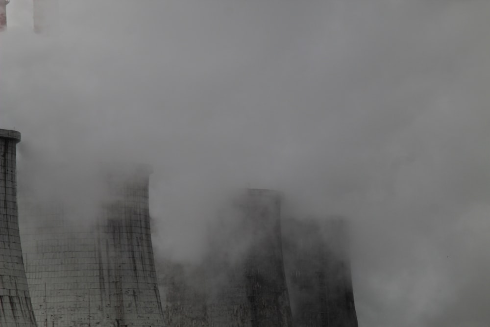 smoke billows from the cooling towers of a factory