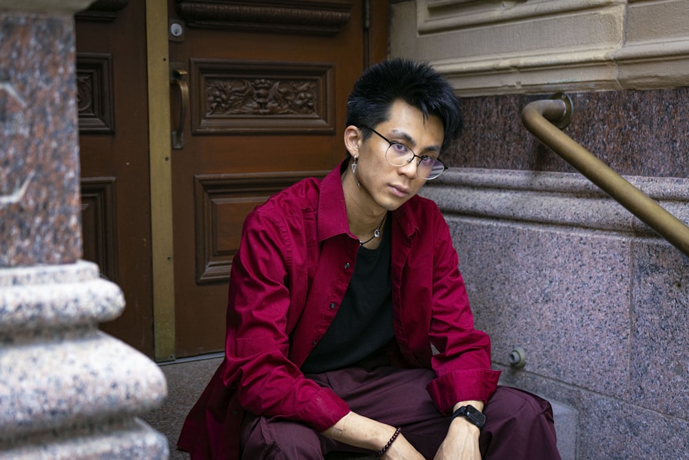 a man sitting on the steps of a building