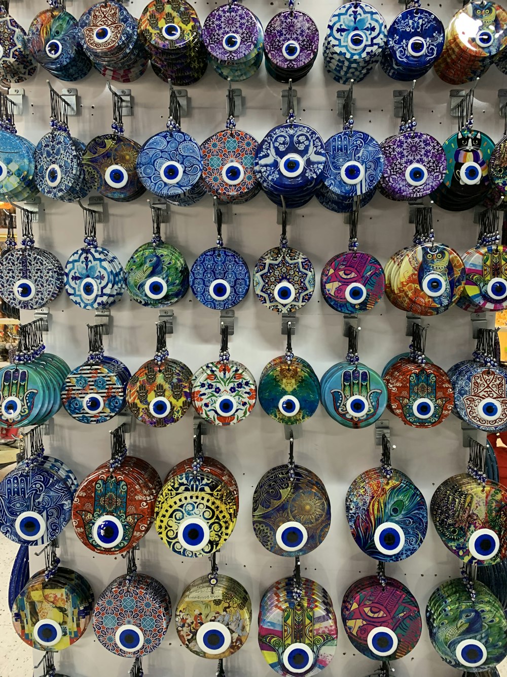 a display of evil looking glass ornaments on a wall