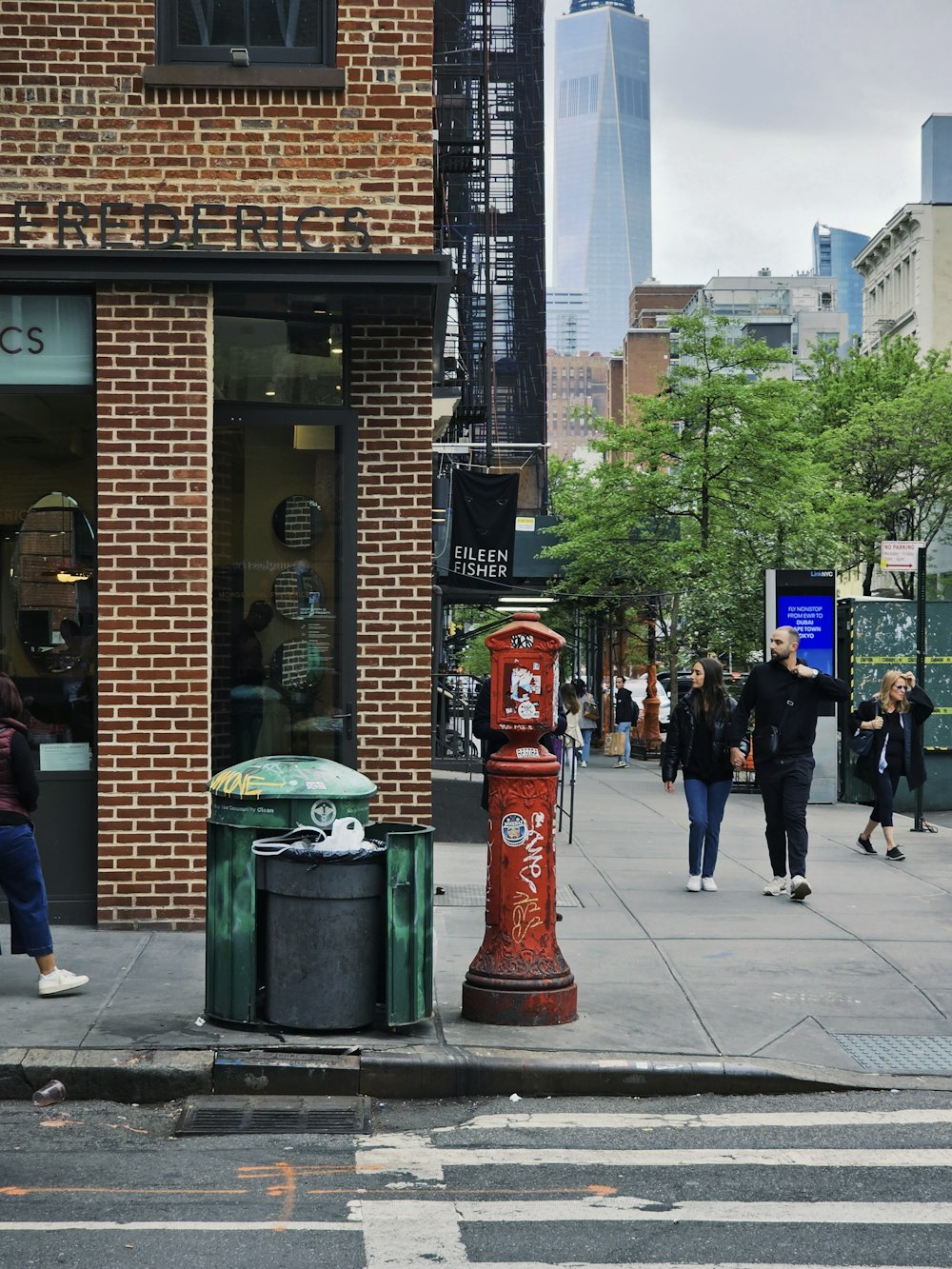 a red fire hydrant sitting on the side of a road