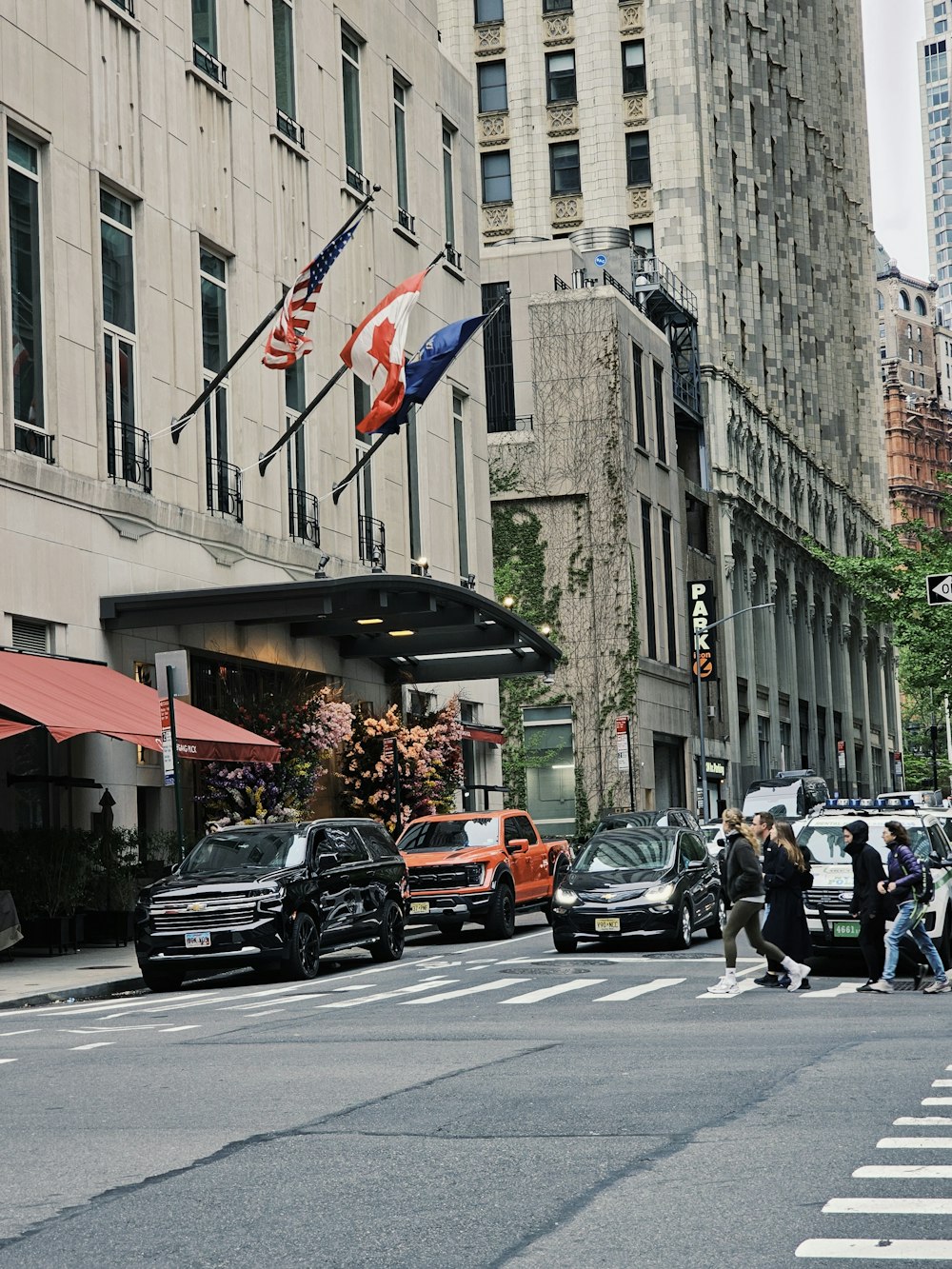 a city street filled with lots of traffic next to tall buildings