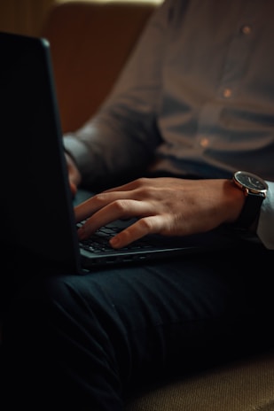 a person using a laptop computer on a couch