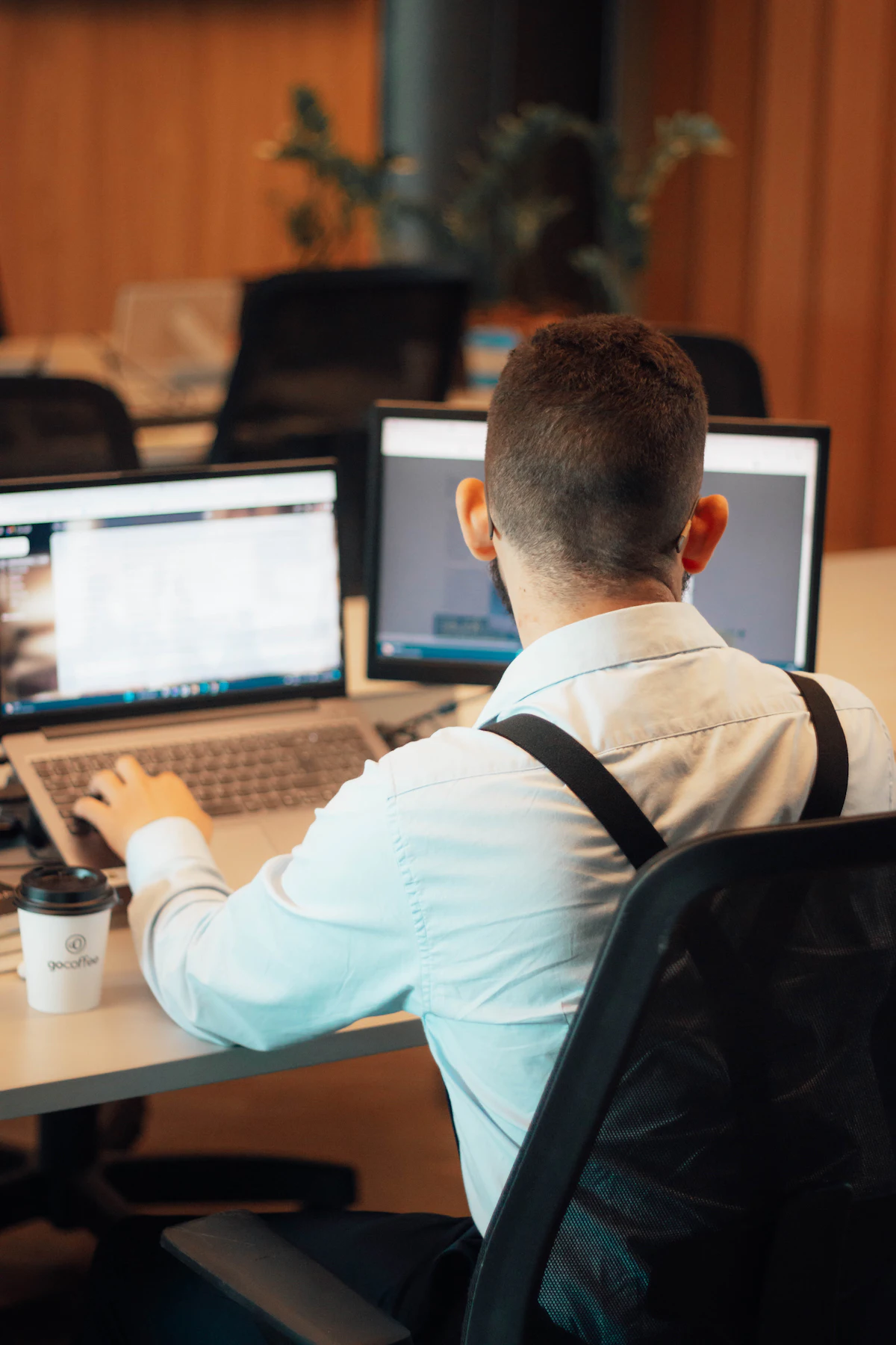 A person sitting in front of a laptop.