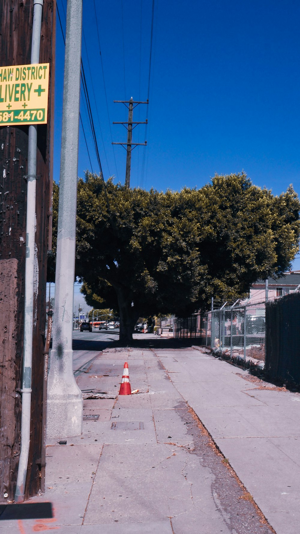 a red fire hydrant sitting on the side of a road