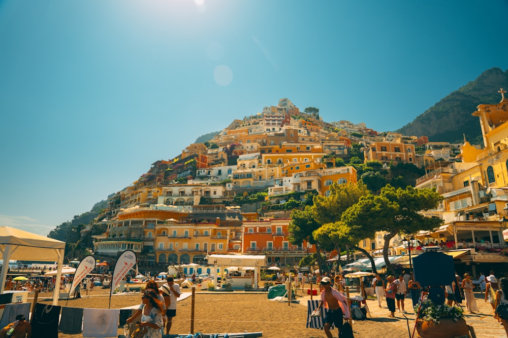 a group of people standing on top of a sandy beach