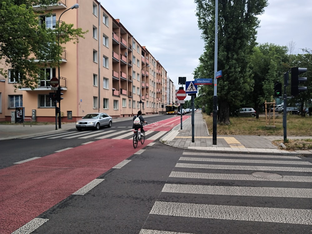 a person riding a bike on a city street