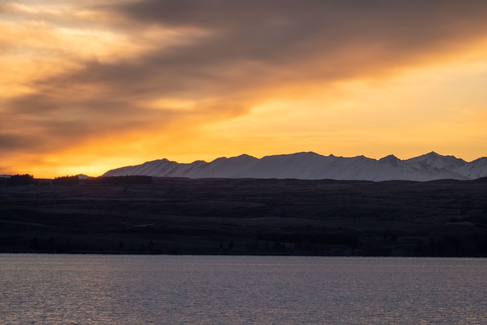 a large body of water with mountains in the background