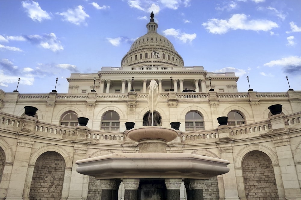 a large building with a fountain in front of it