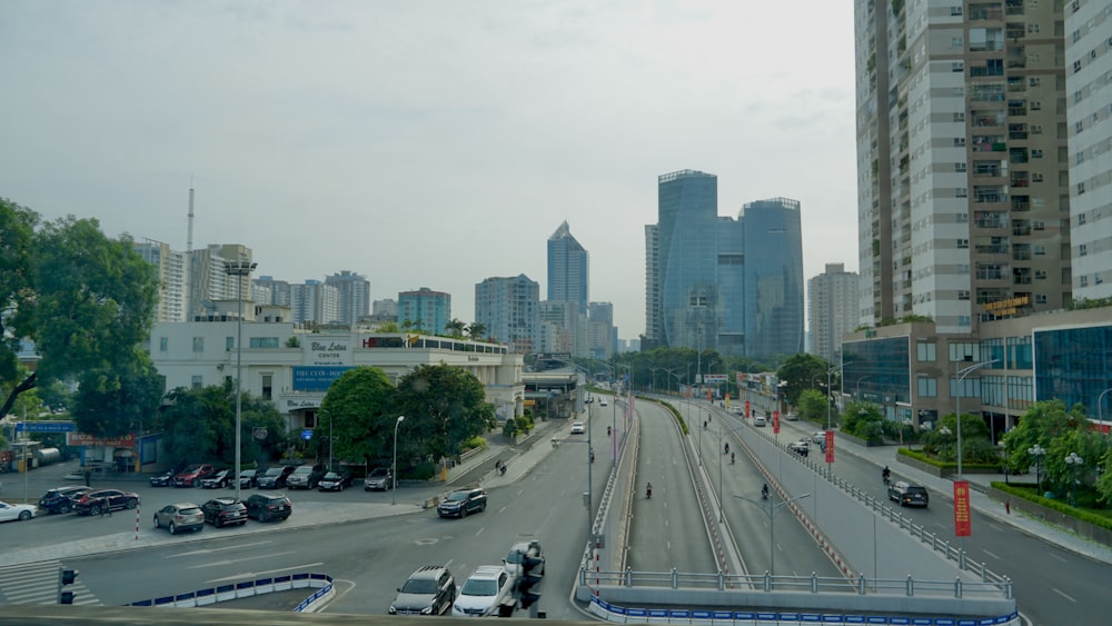 a busy city street with tall buildings in the background