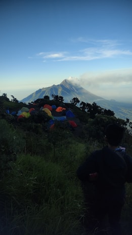 A scenic multi-day expedition group setting up camp near a mountain base.