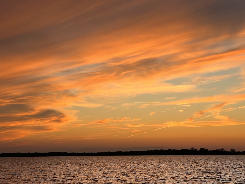 a large body of water under a cloudy sky