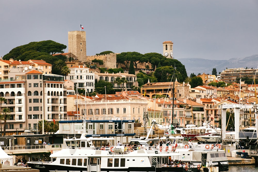 a harbor filled with lots of boats next to tall buildings