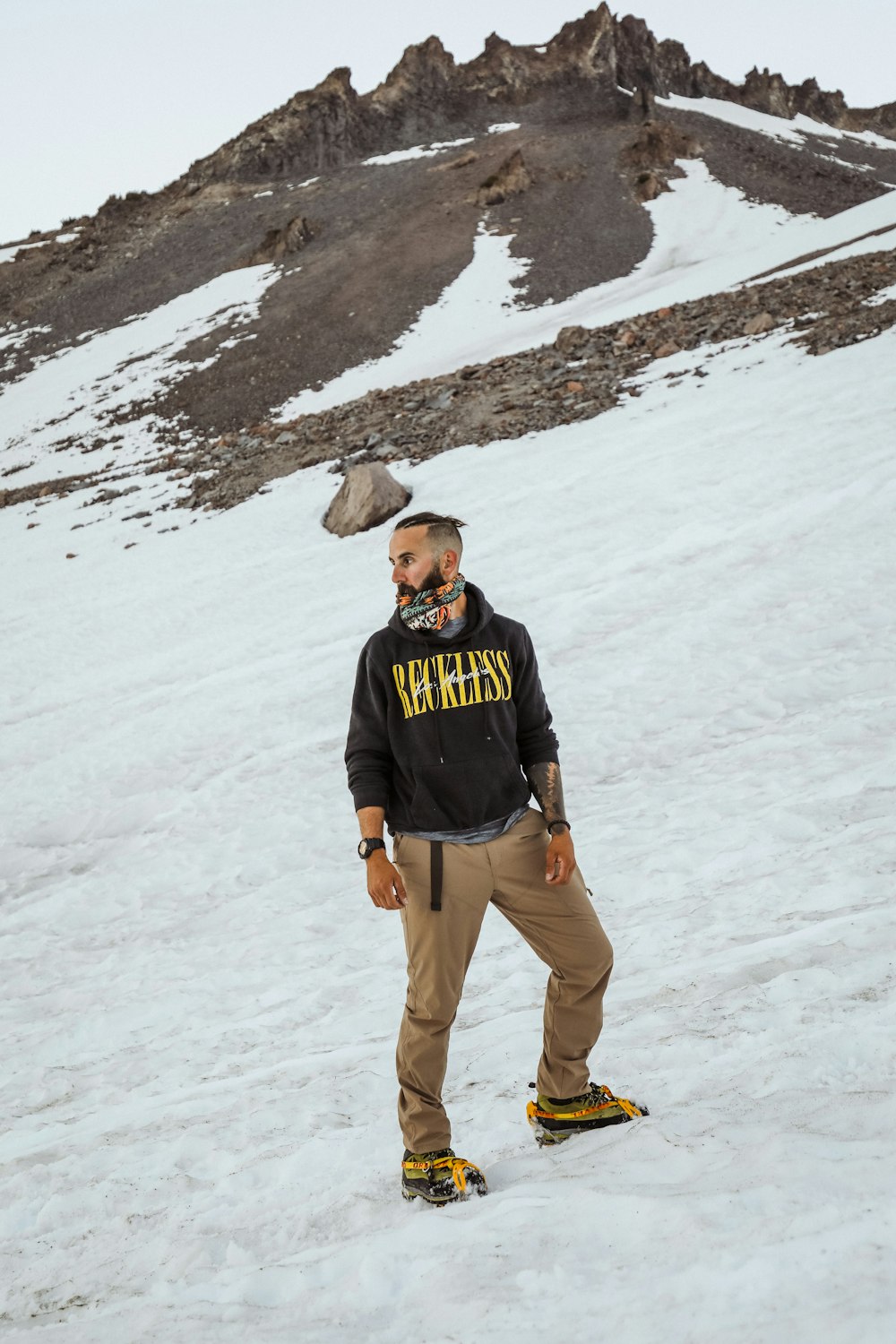 a man standing on top of a snow covered slope