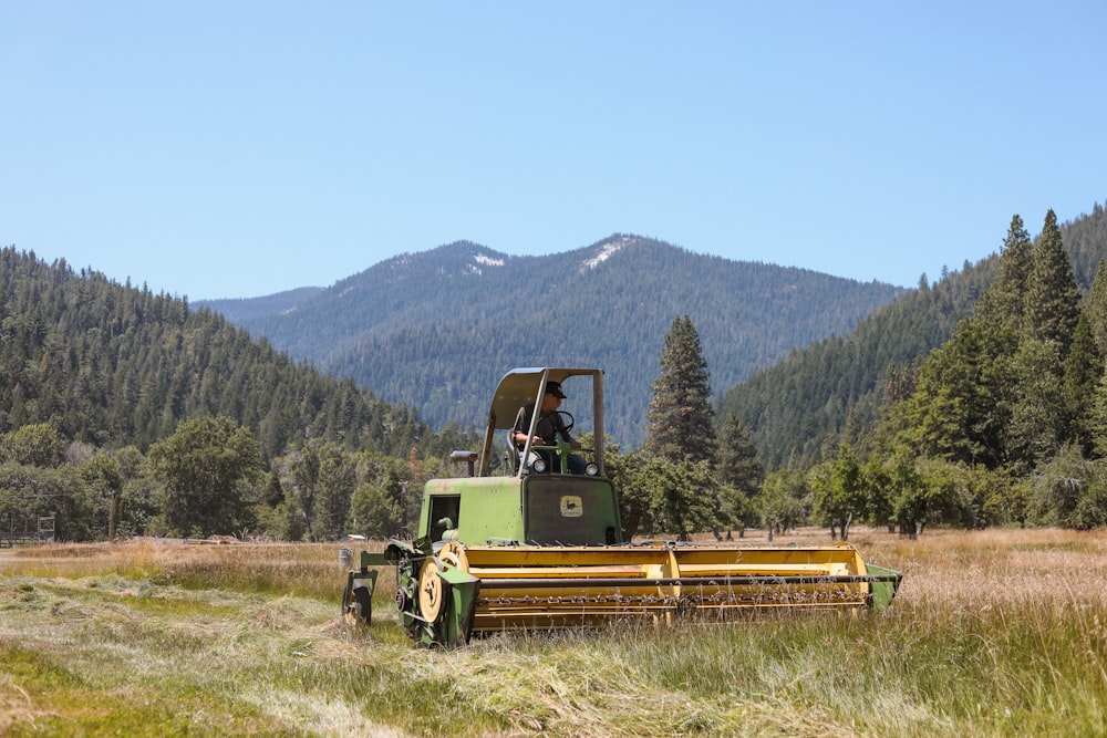 a tractor is parked in a field with mountains in the background