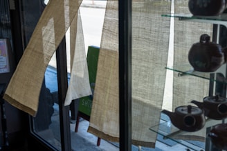 A cozy NYC tea shop corner with wooden shelves lined with classic Chinese tea tins and soft natural light.