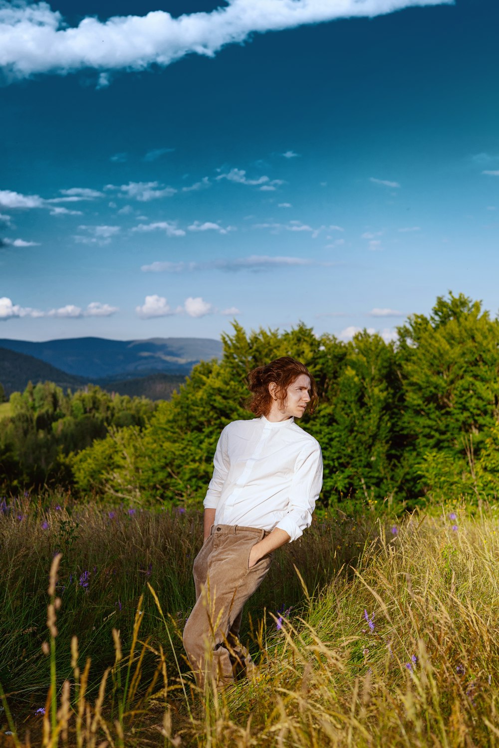 a man standing in a field of tall grass