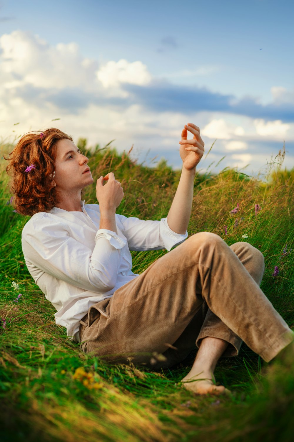 eine frau, die auf dem boden in einem feld sitzt