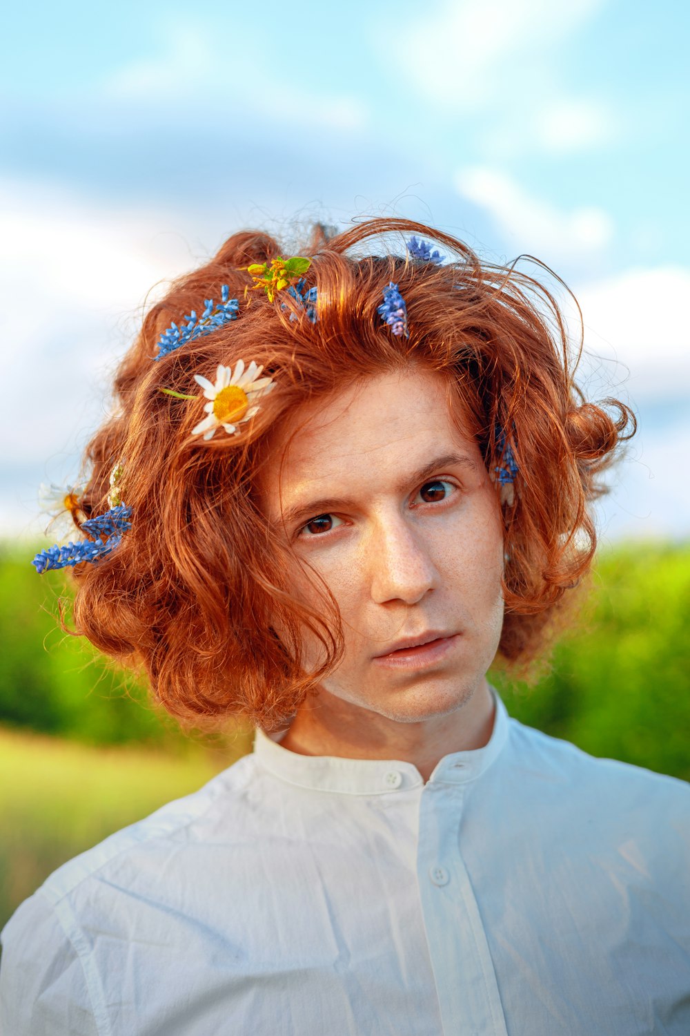 a woman with red hair and flowers in her hair