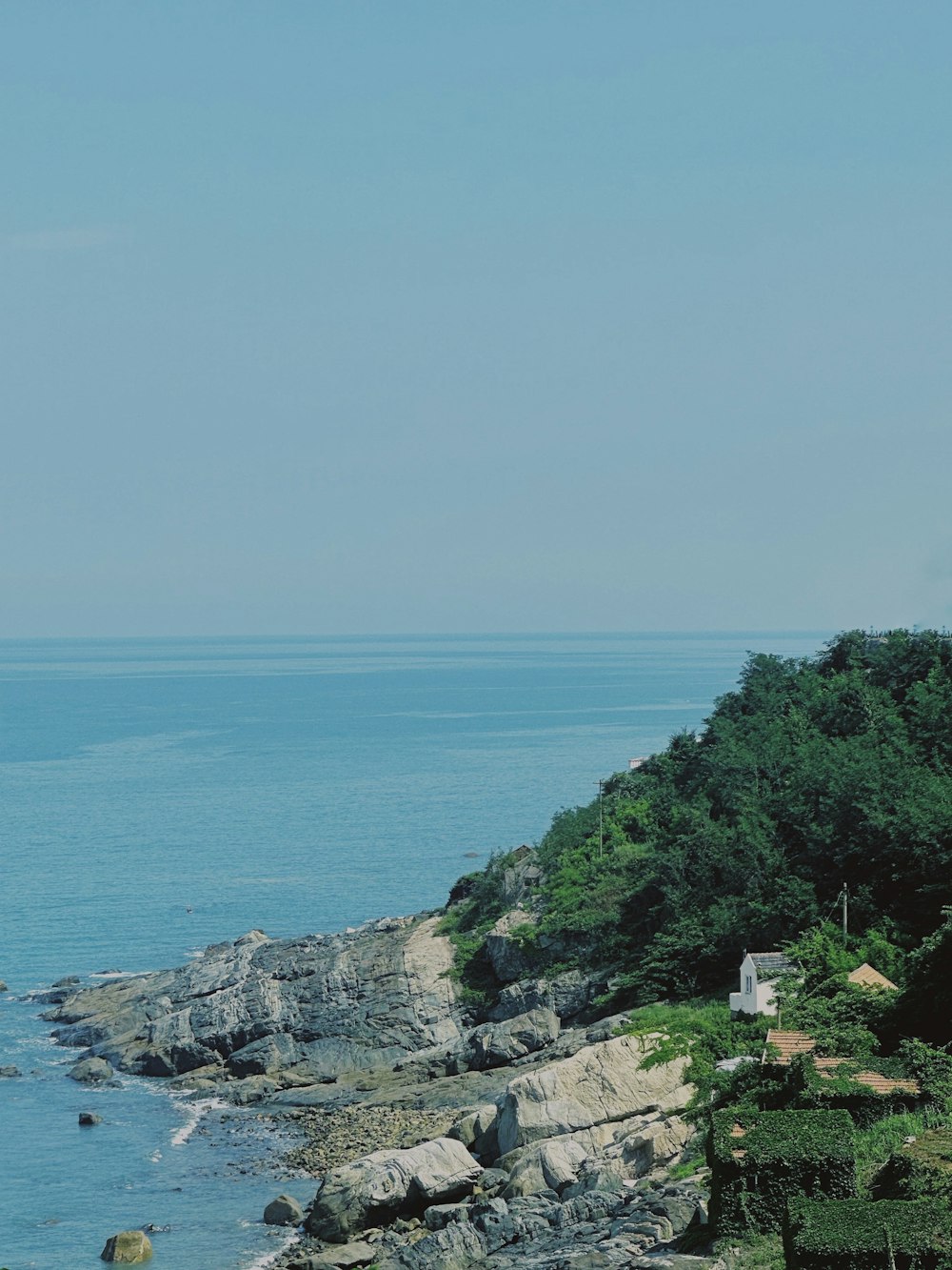 a view of the ocean from a rocky shore