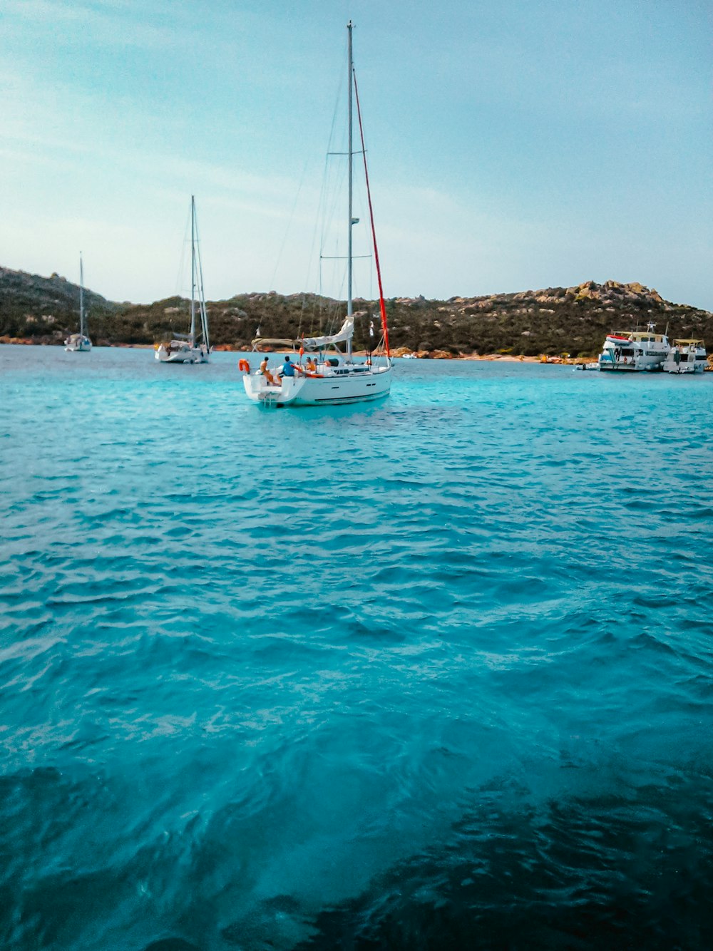 a group of boats floating on top of a body of water