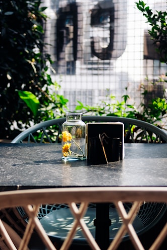 a table with a vase of flowers on top of it