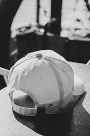 a black and white photo of a hat on a table