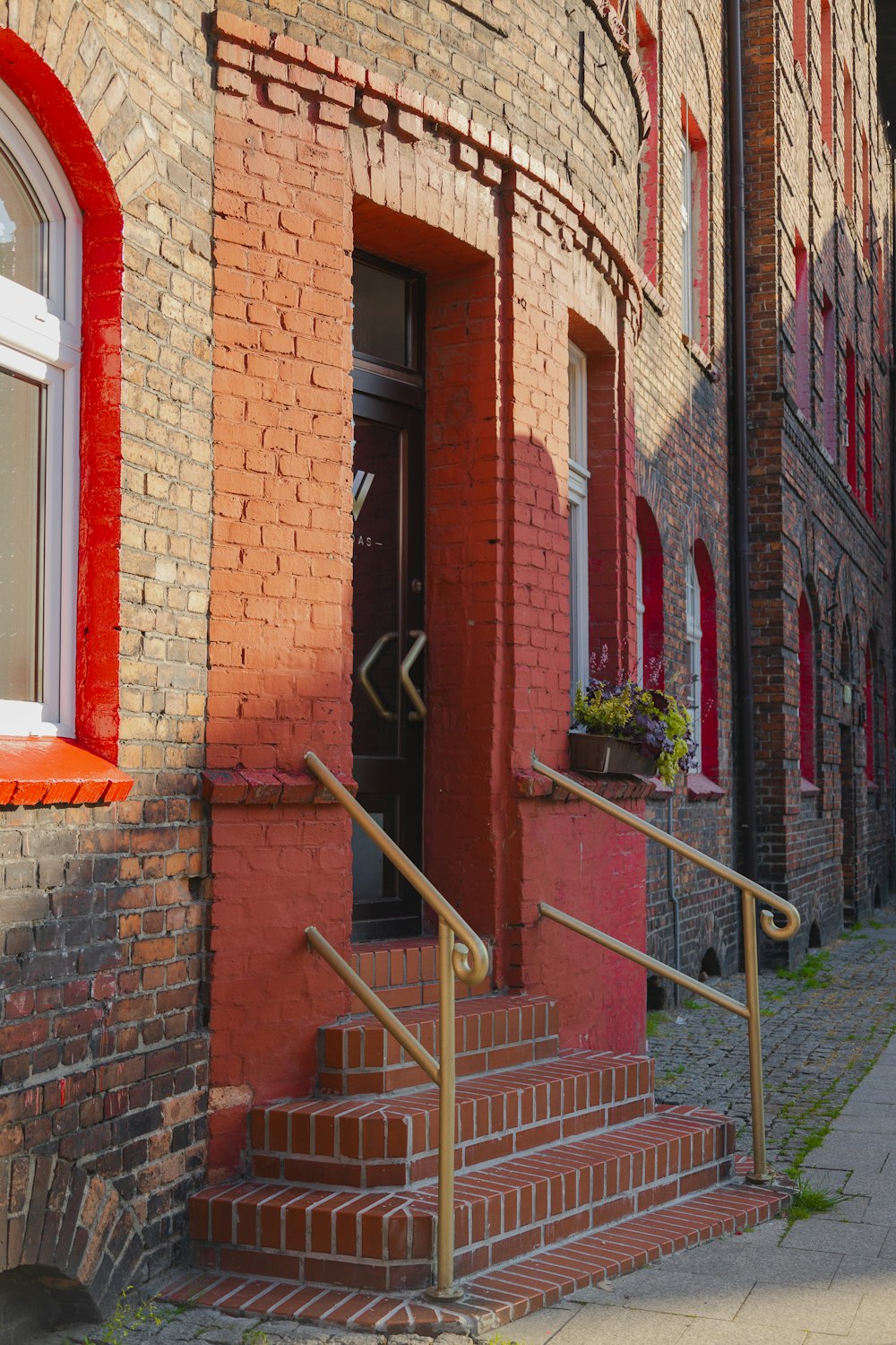 a red brick building with stairs leading up to it