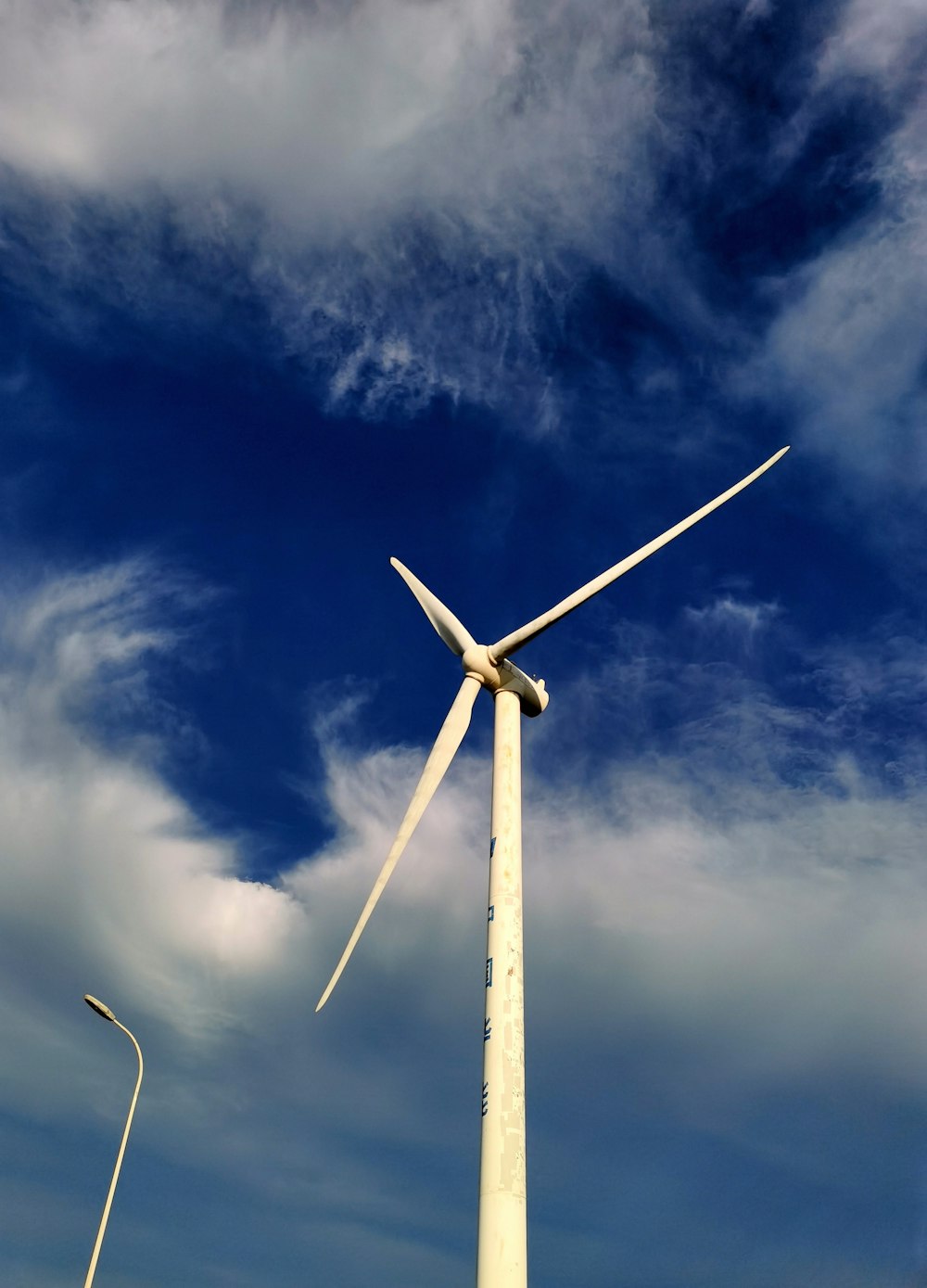 a wind turbine is shown against a blue sky