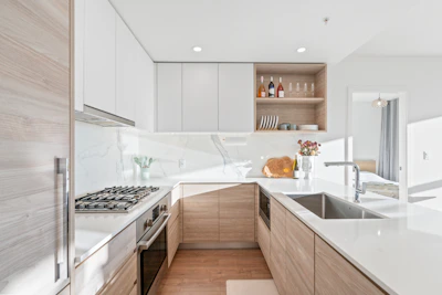 A bright kitchen with fresh cabinets and updated natural gas installation.