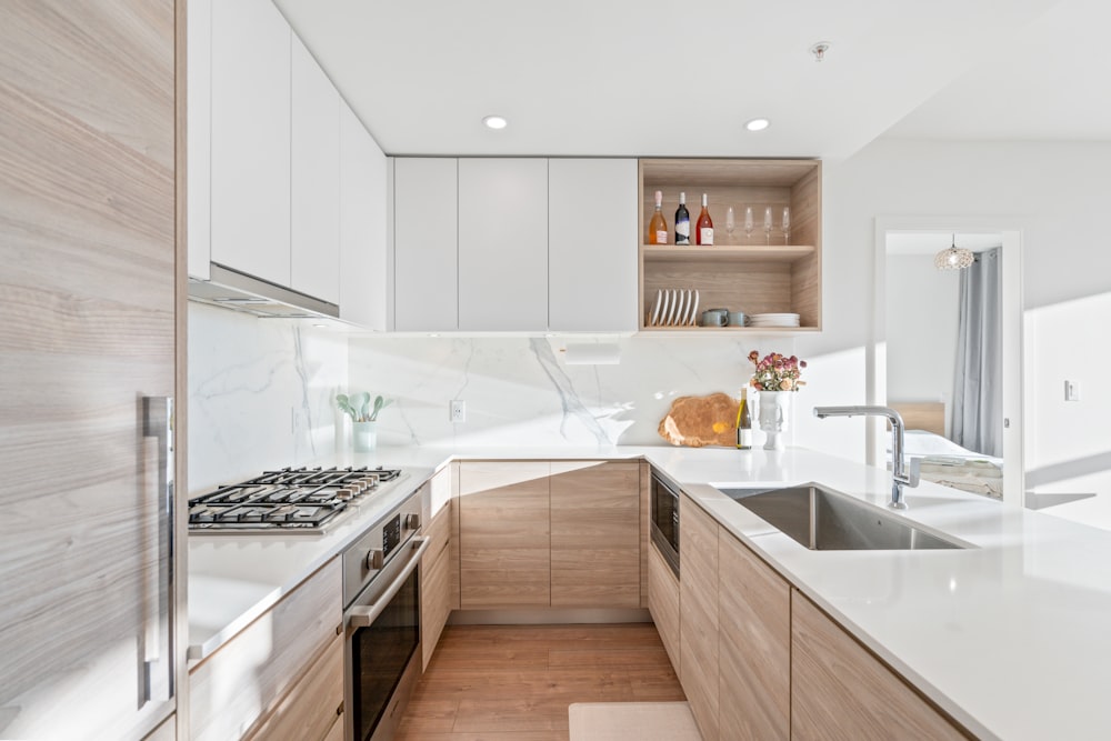 a kitchen with a stove top oven next to a sink