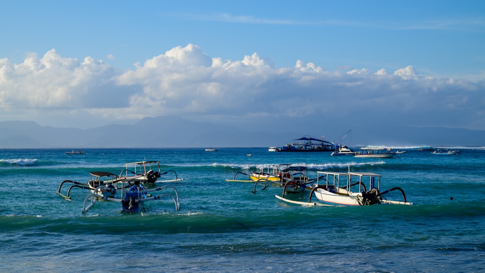 a group of boats floating on top of a body of water