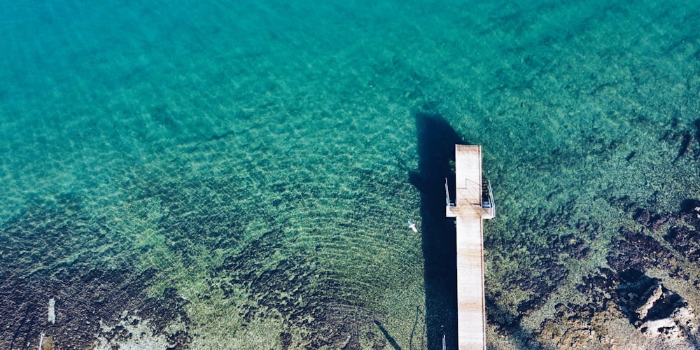 an aerial view of a pier in the water