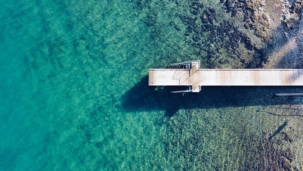 an aerial view of a pier in the water